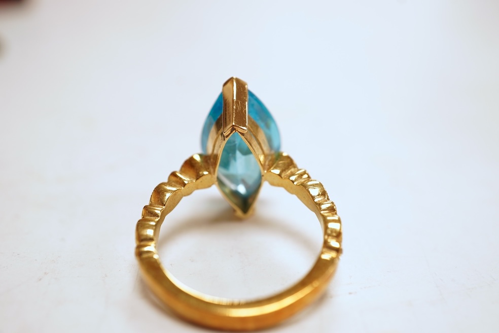 A cubic zirconia and diamond ring, set with a marquise-shaped blue cubic zirconia, to shoulders set with brilliant-cut diamonds, mounted in gold, size Q1/2, stamped 585, gross weight 8 grams, Condition: minor discolorati